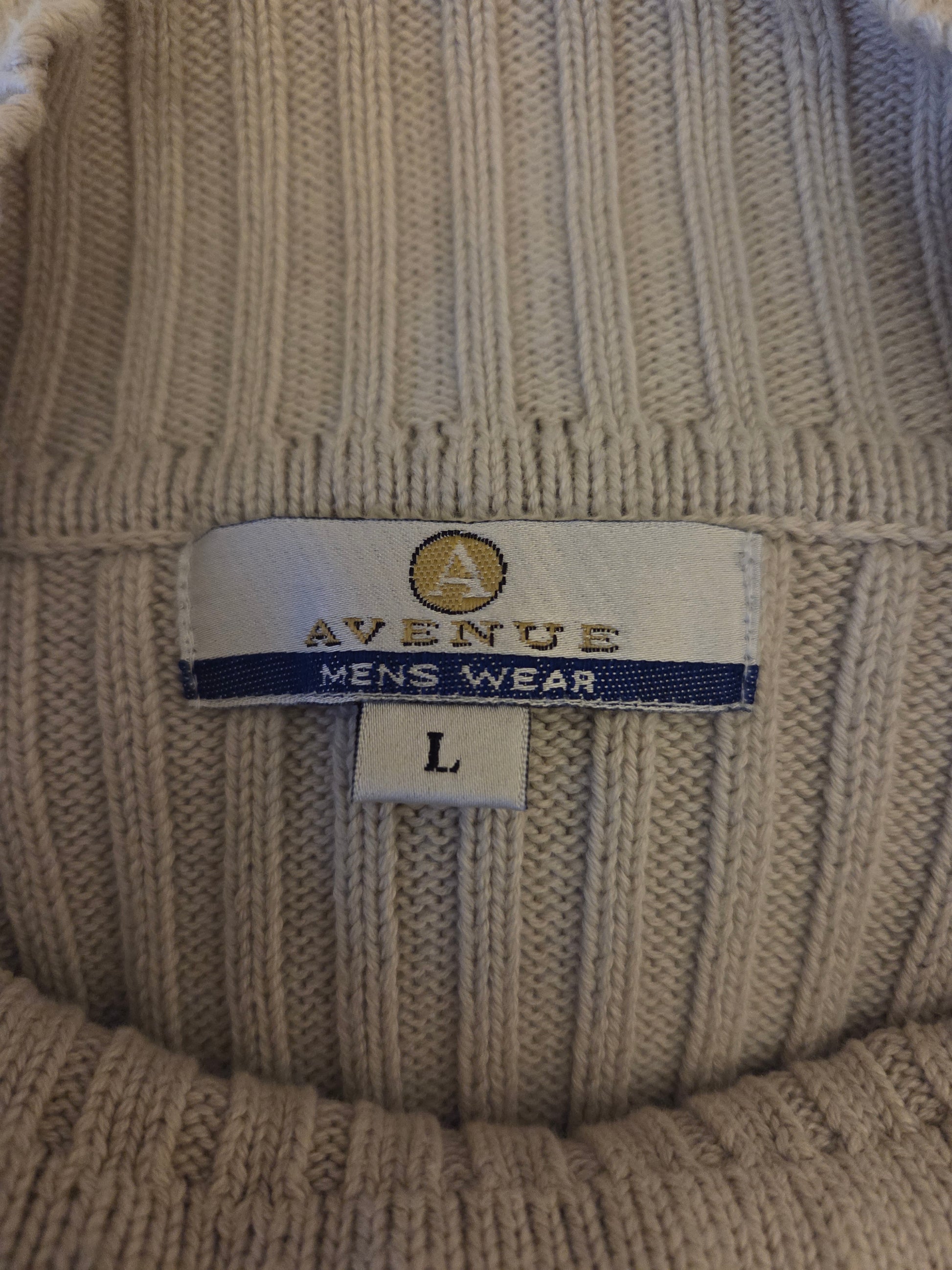 Close-up of a label on a textured jumper with 'Avenue' branding.