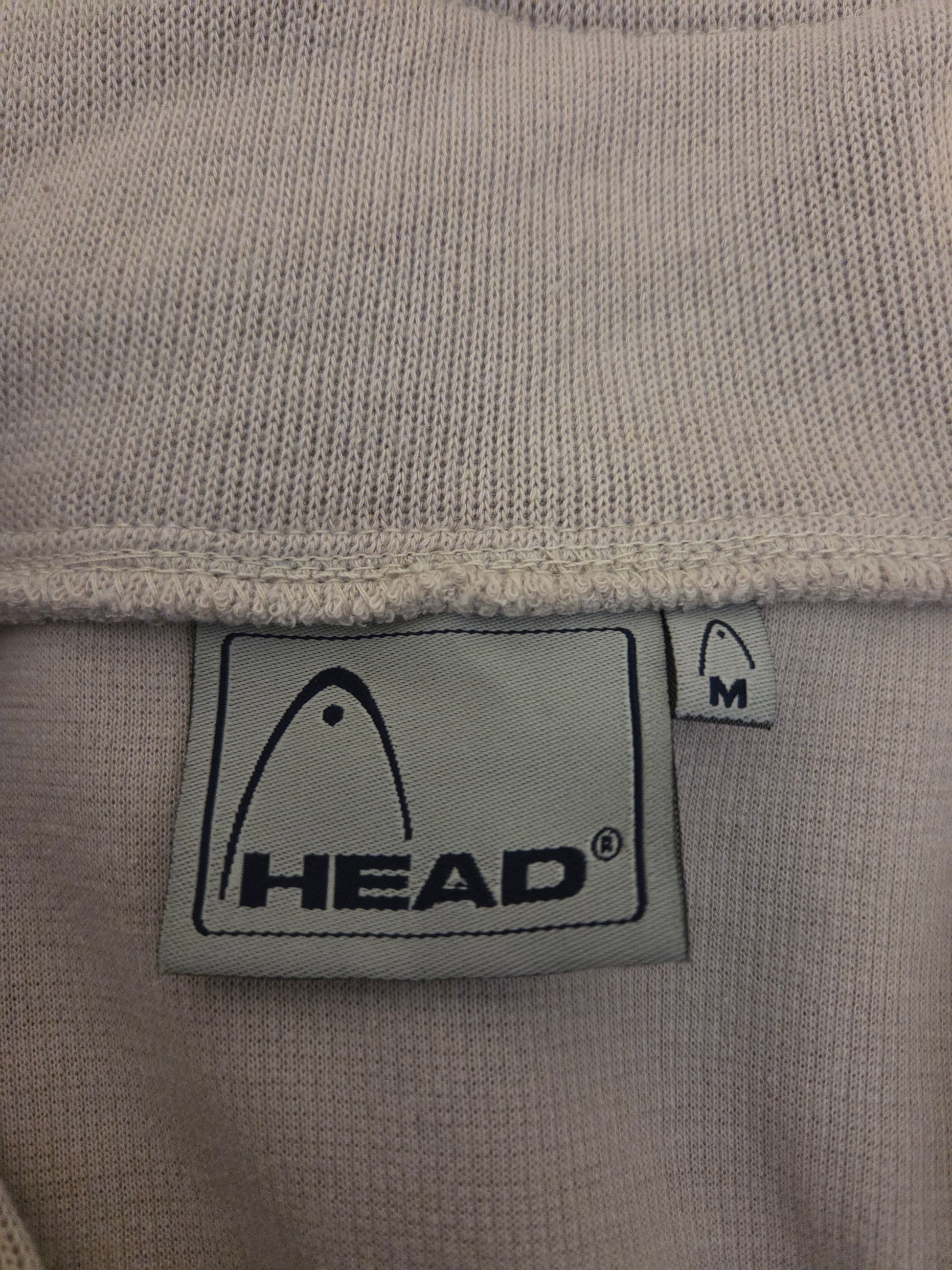 beige fabric with a HEAD size label 