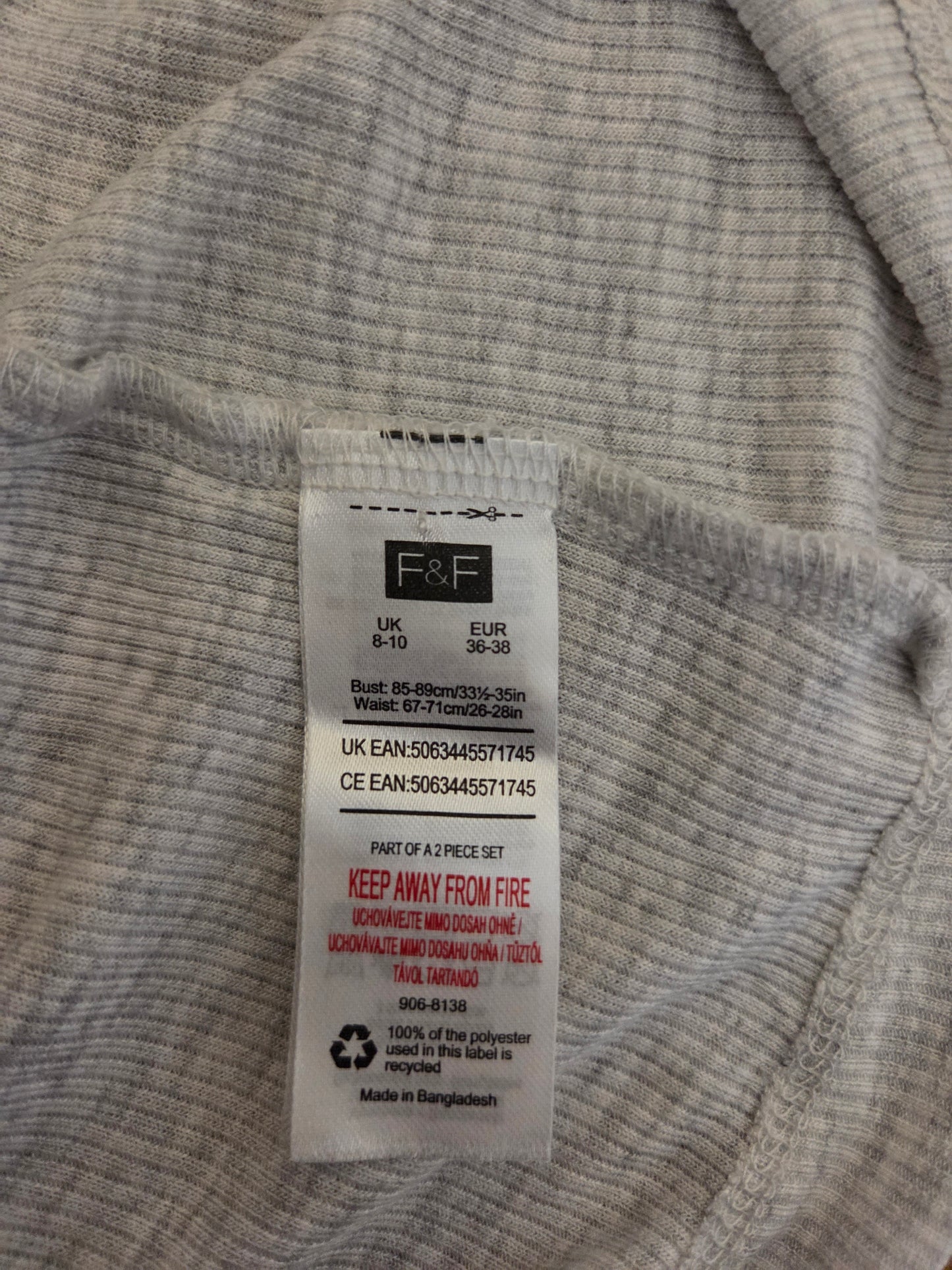 Close-up of a size tag on a grey fabric