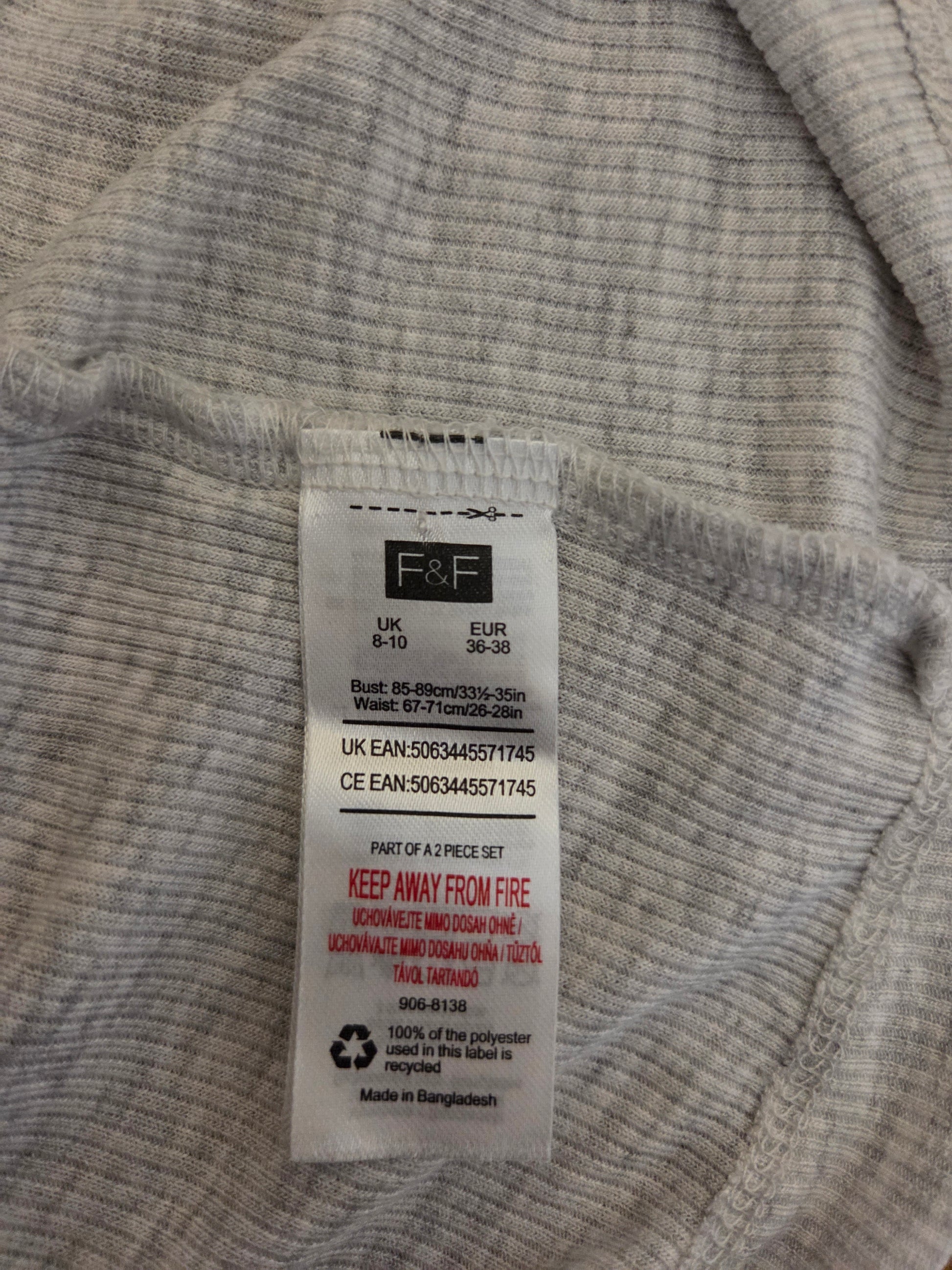 Close-up of a size tag on a grey fabric