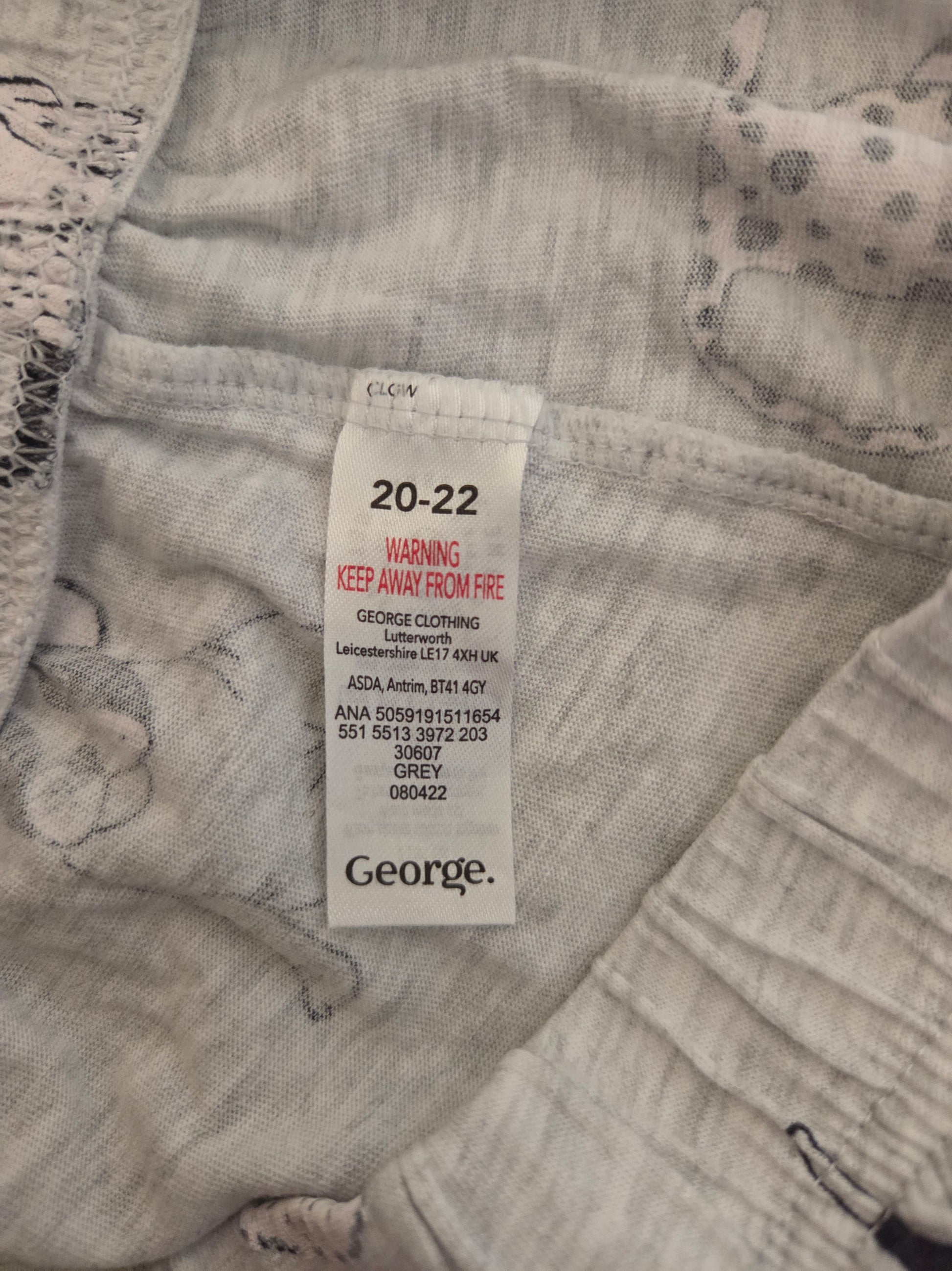Clothing tag on a piece of fabric with 'George' branding