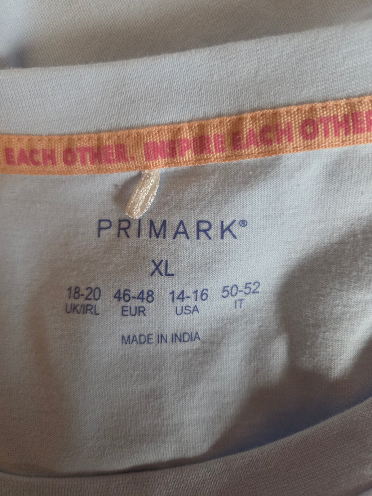 Size label on a light blue material