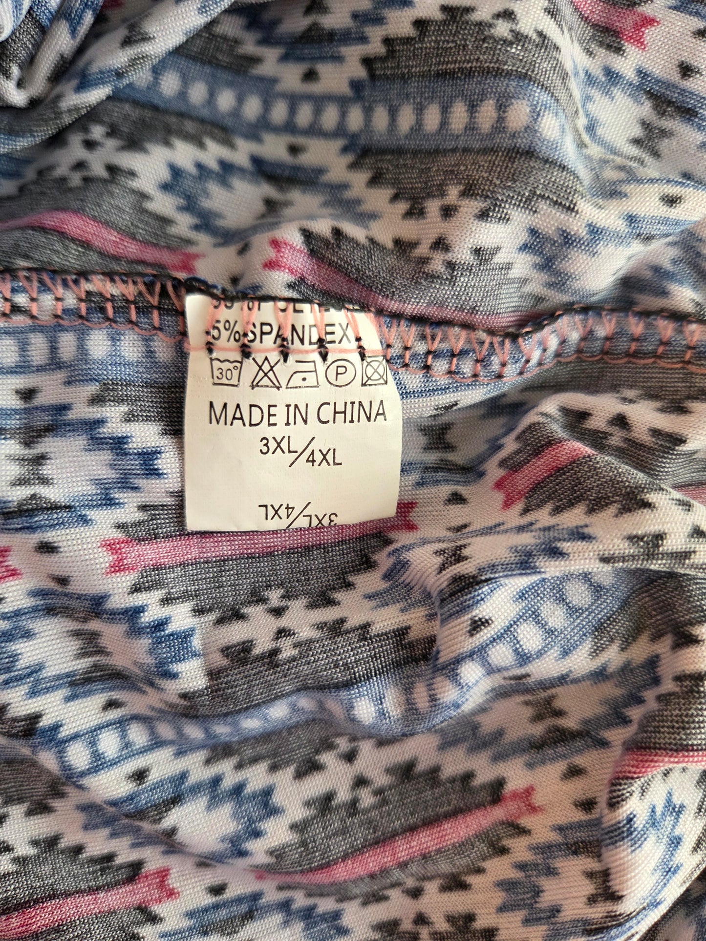 Fabric with a patterned label indicating 'Made in China' and size information.