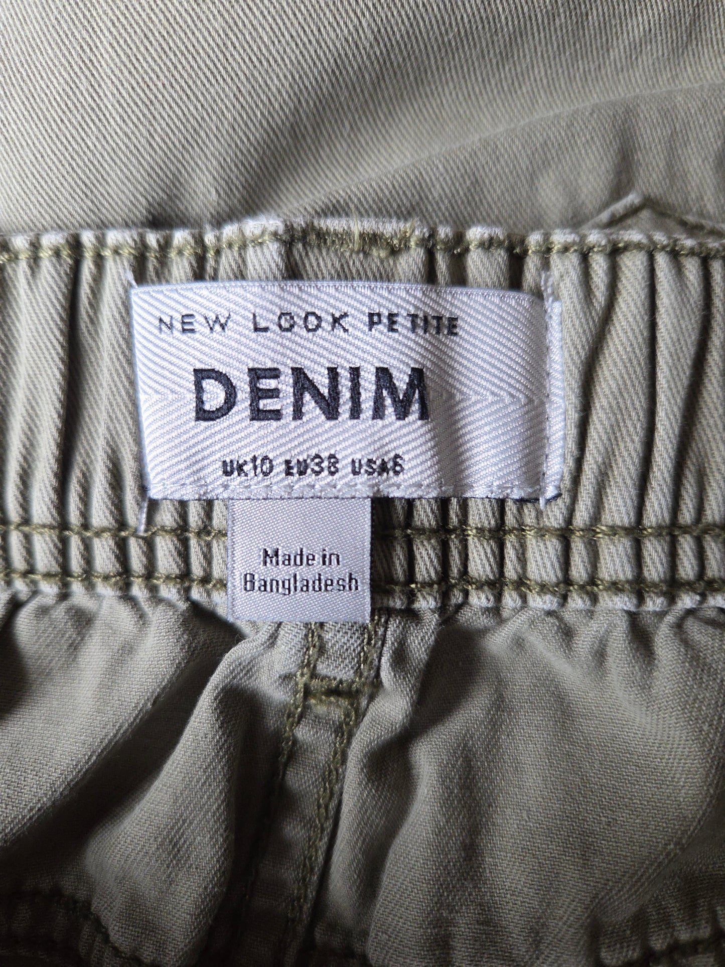 Denim label on a pair of jeans with text indicating size and origin.