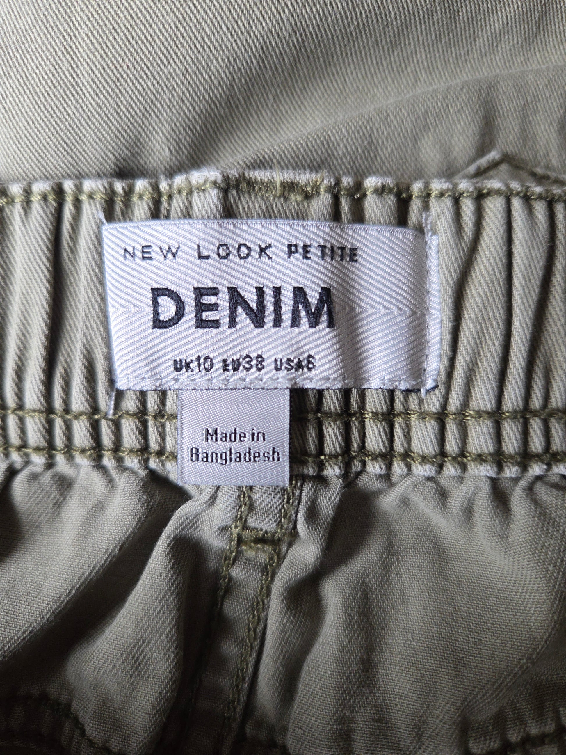 Denim label on a pair of jeans with text indicating size and origin.