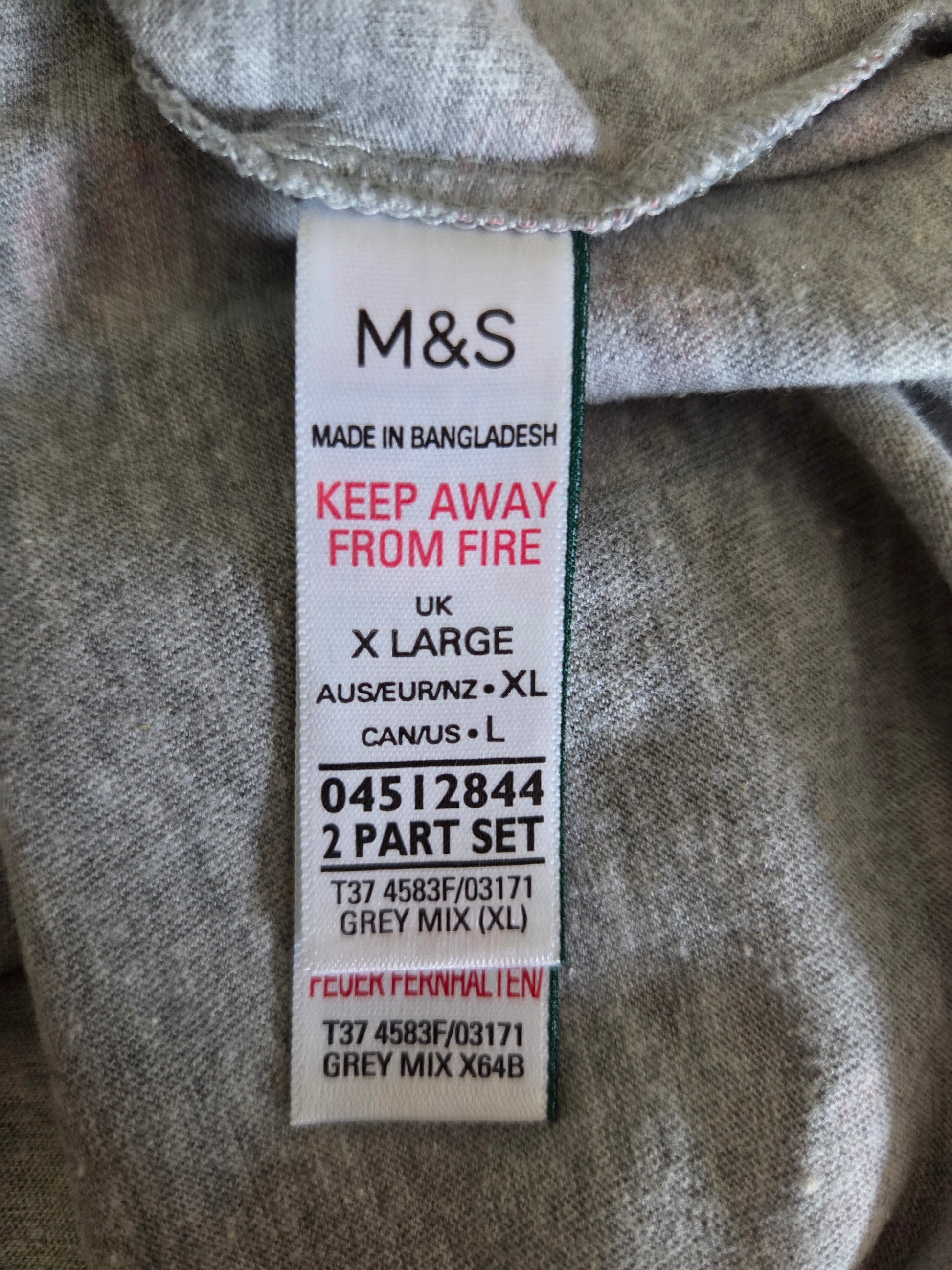 M&S size label on a piece of grey fabric