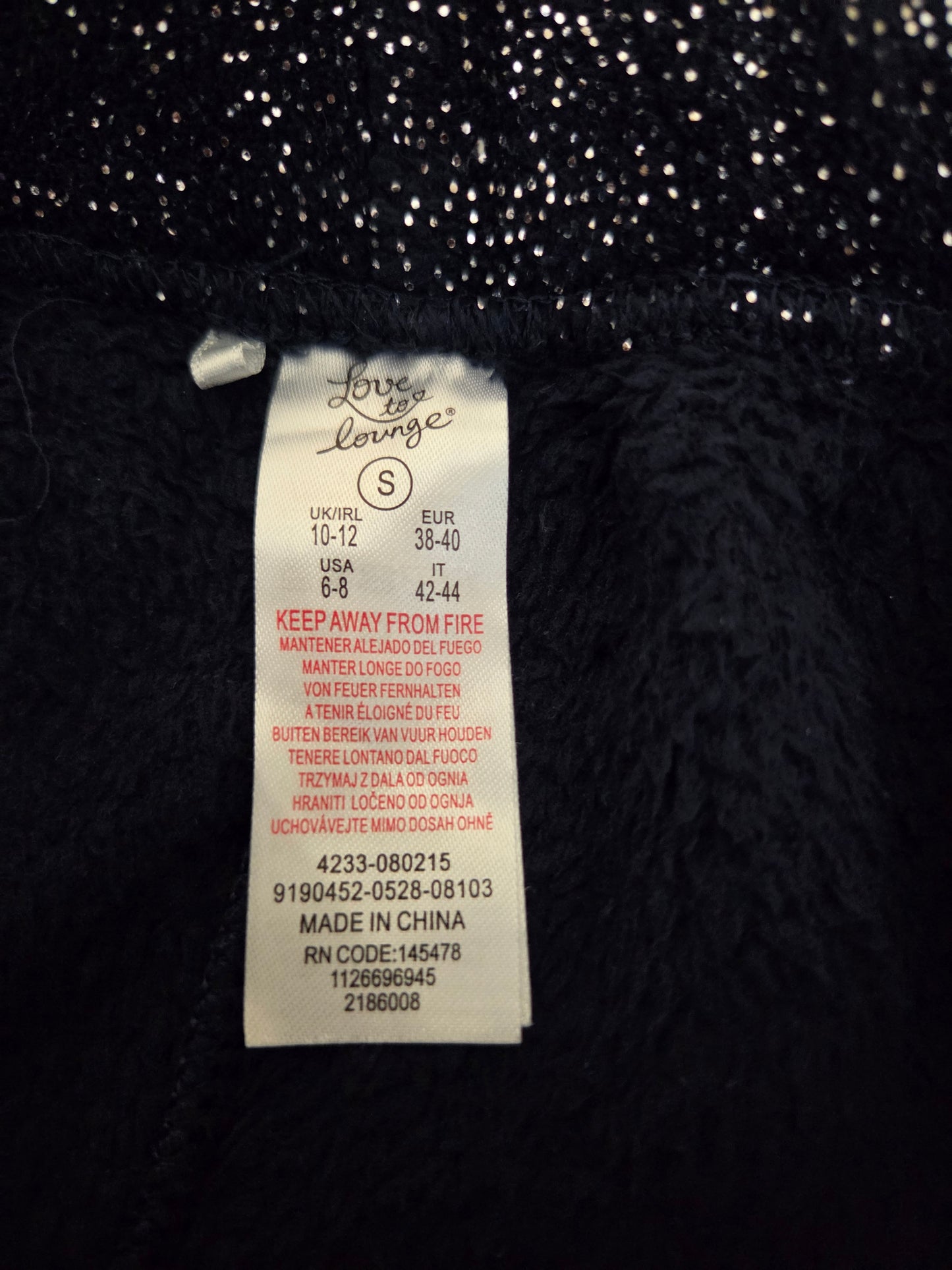 Close-up of a size label on a navy textured fabric 