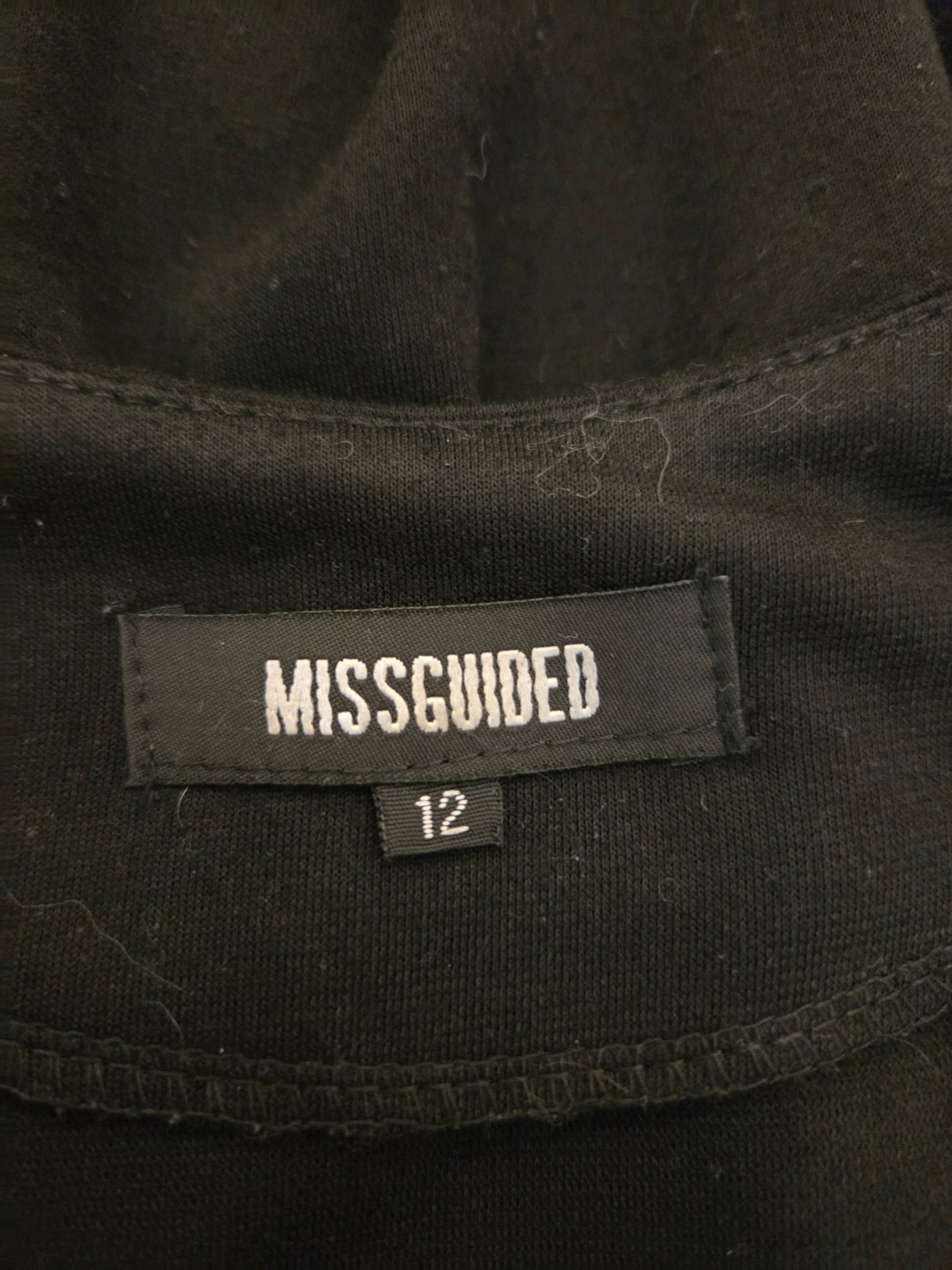 Black clothing with a 'Missguided' label 