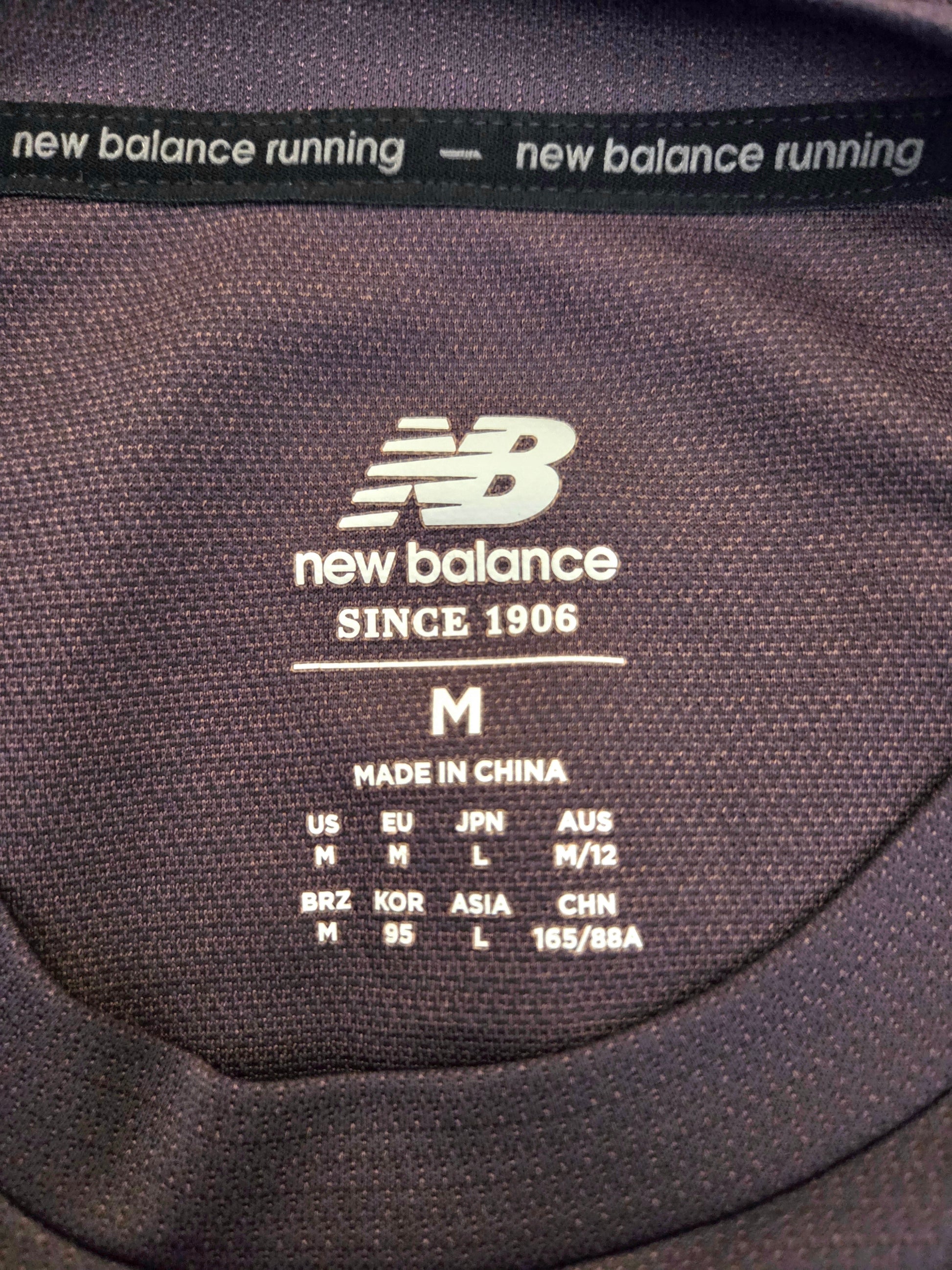 New Balance label on a piece of clothing with size information.
