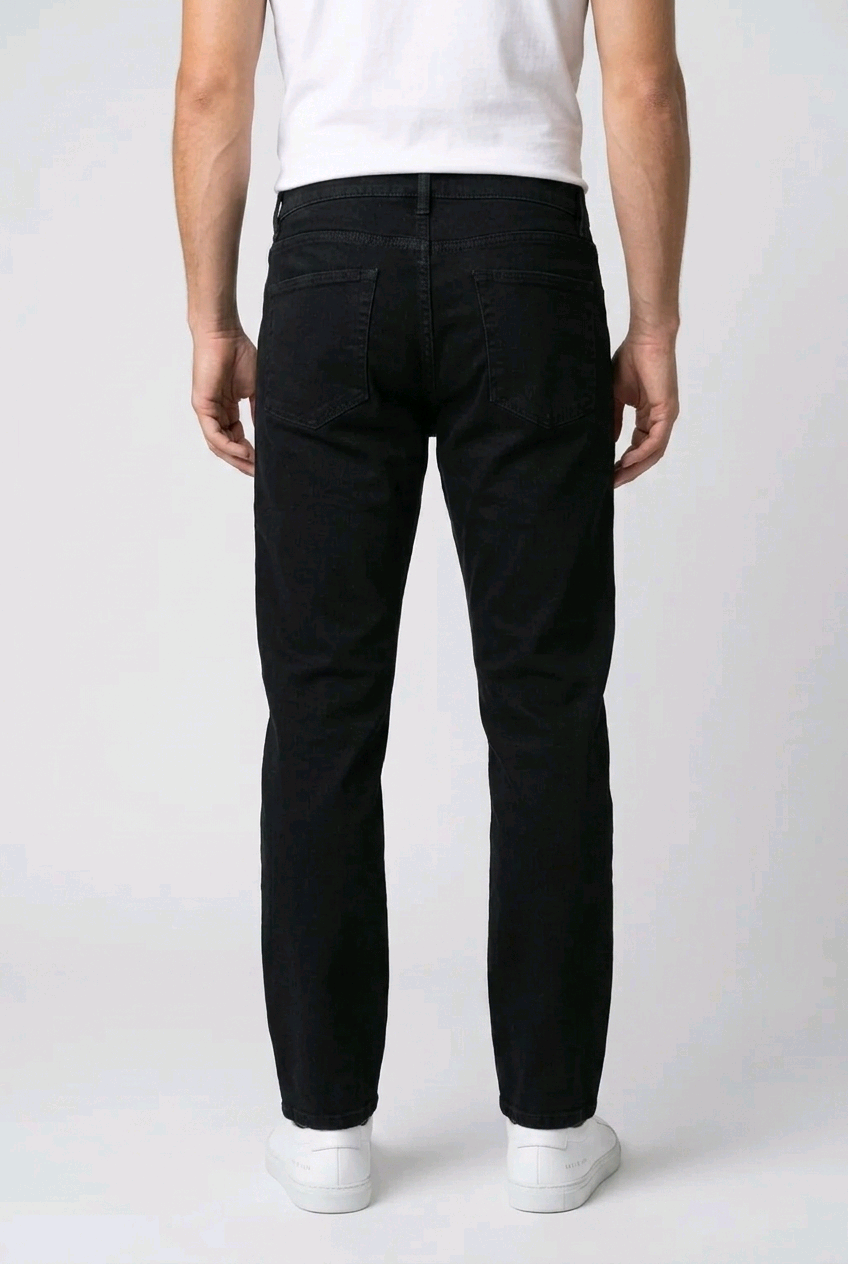 Man wearing black jeans and a white shirt 