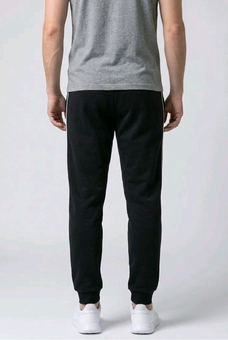 Man wearing black joggers and a grey shirt 