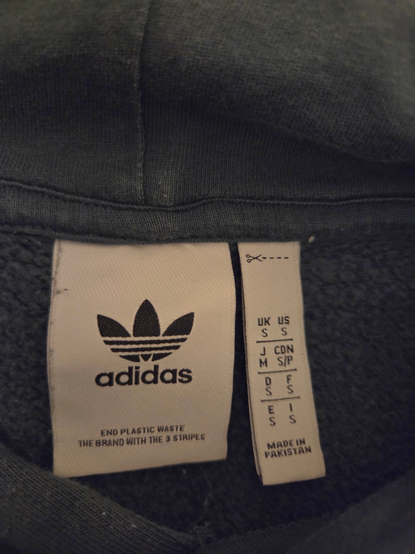 Adidas Originals green hoodie label with size and care instructions