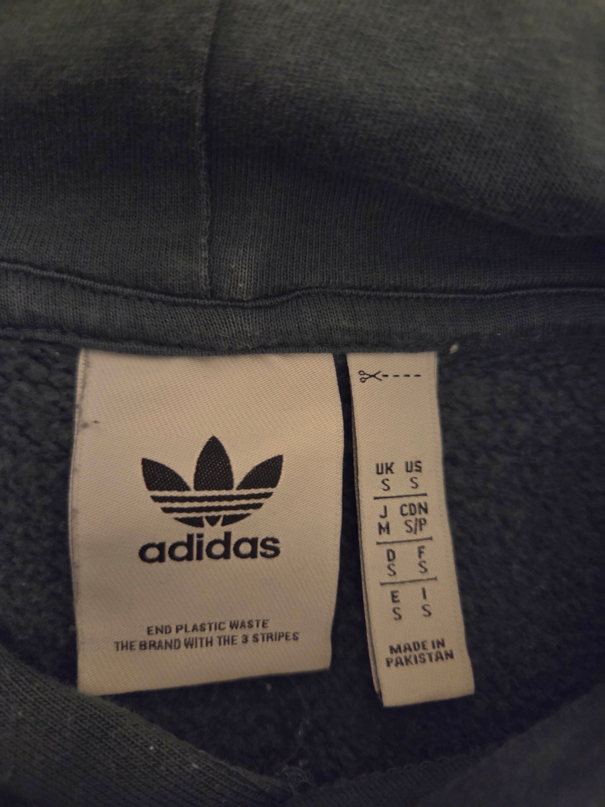 Adidas Originals green hoodie label with size and care instructions