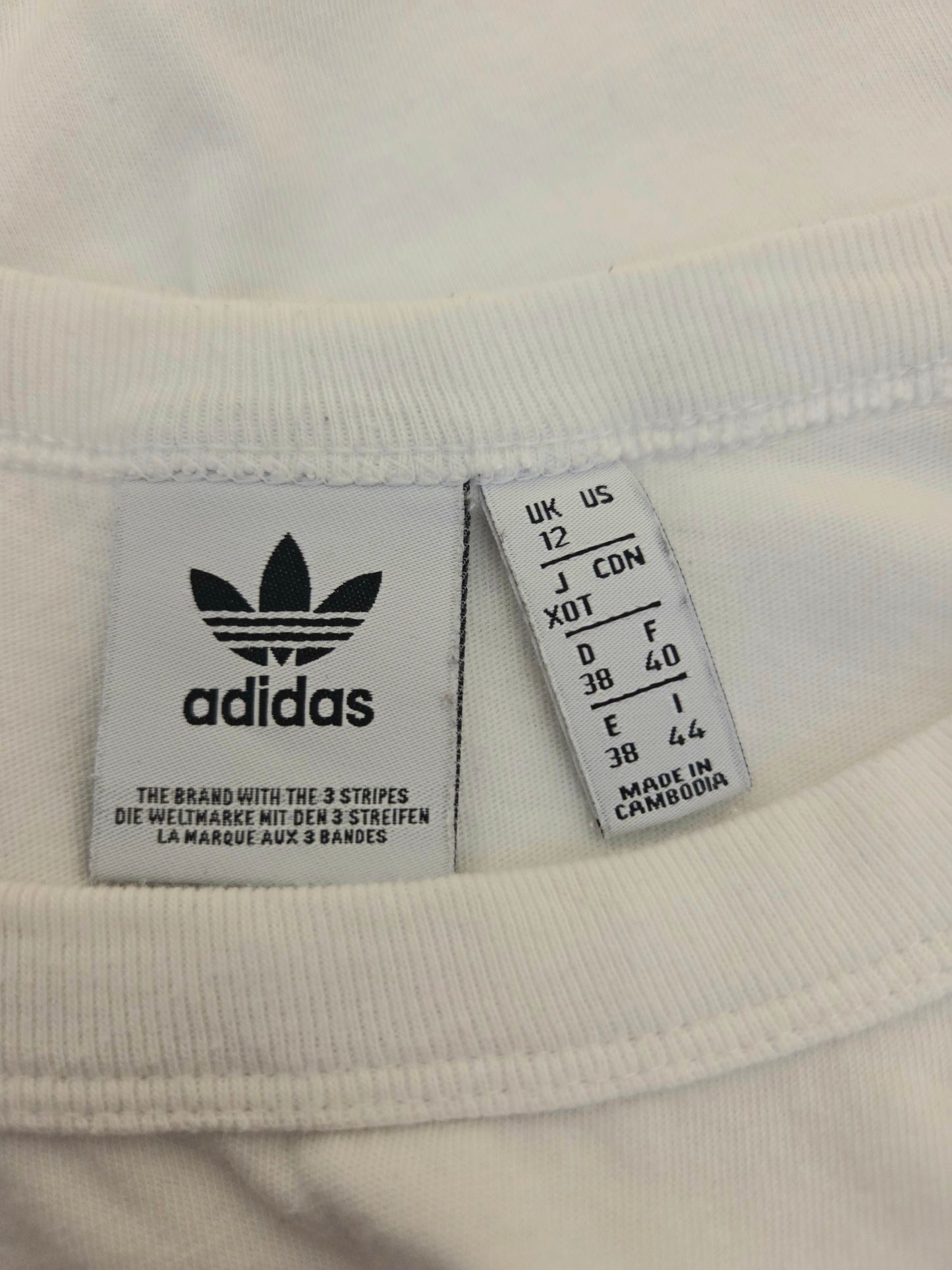 Adidas size label on a white fabric 