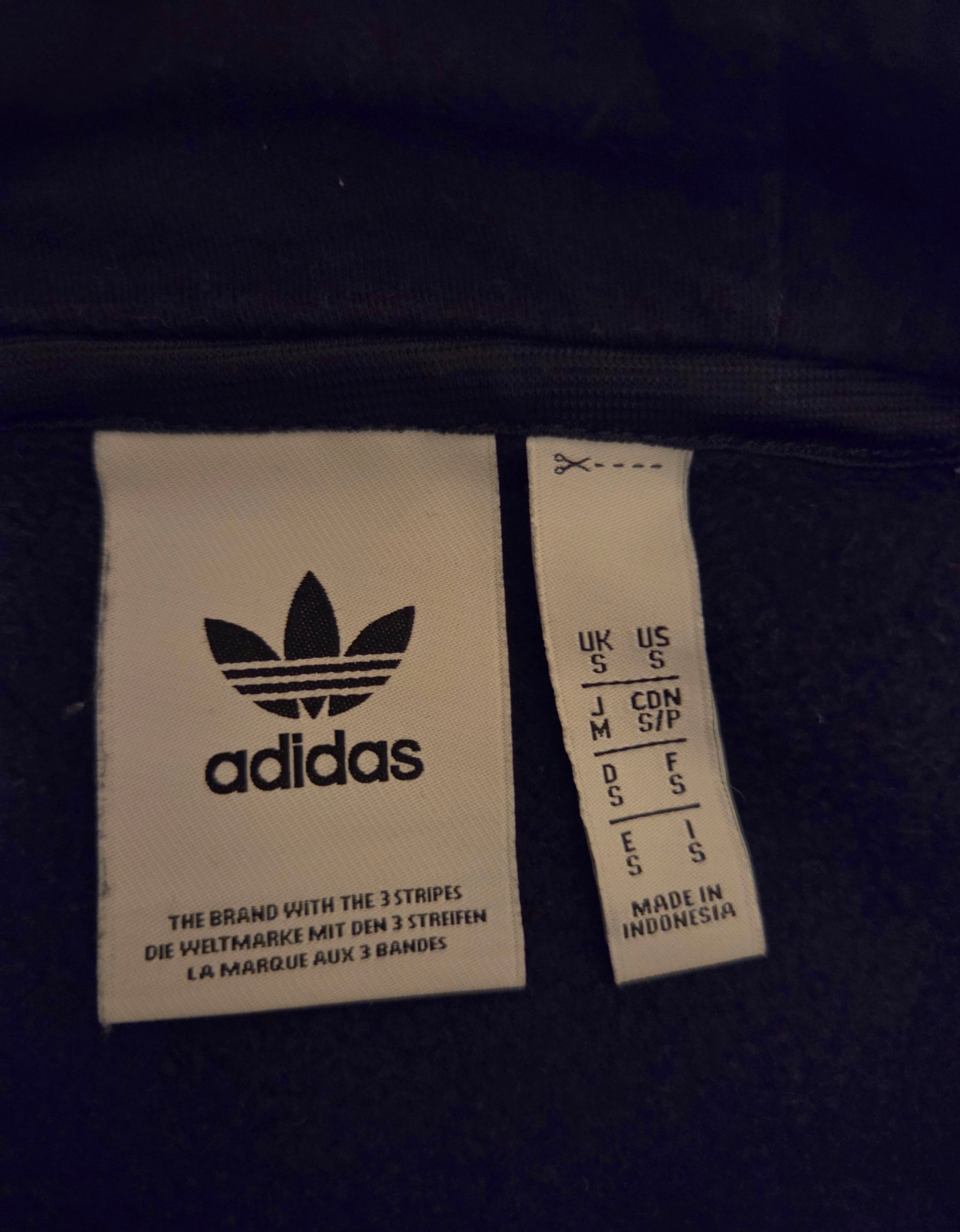 Adidas Trefoil logo tag with size and care instructions