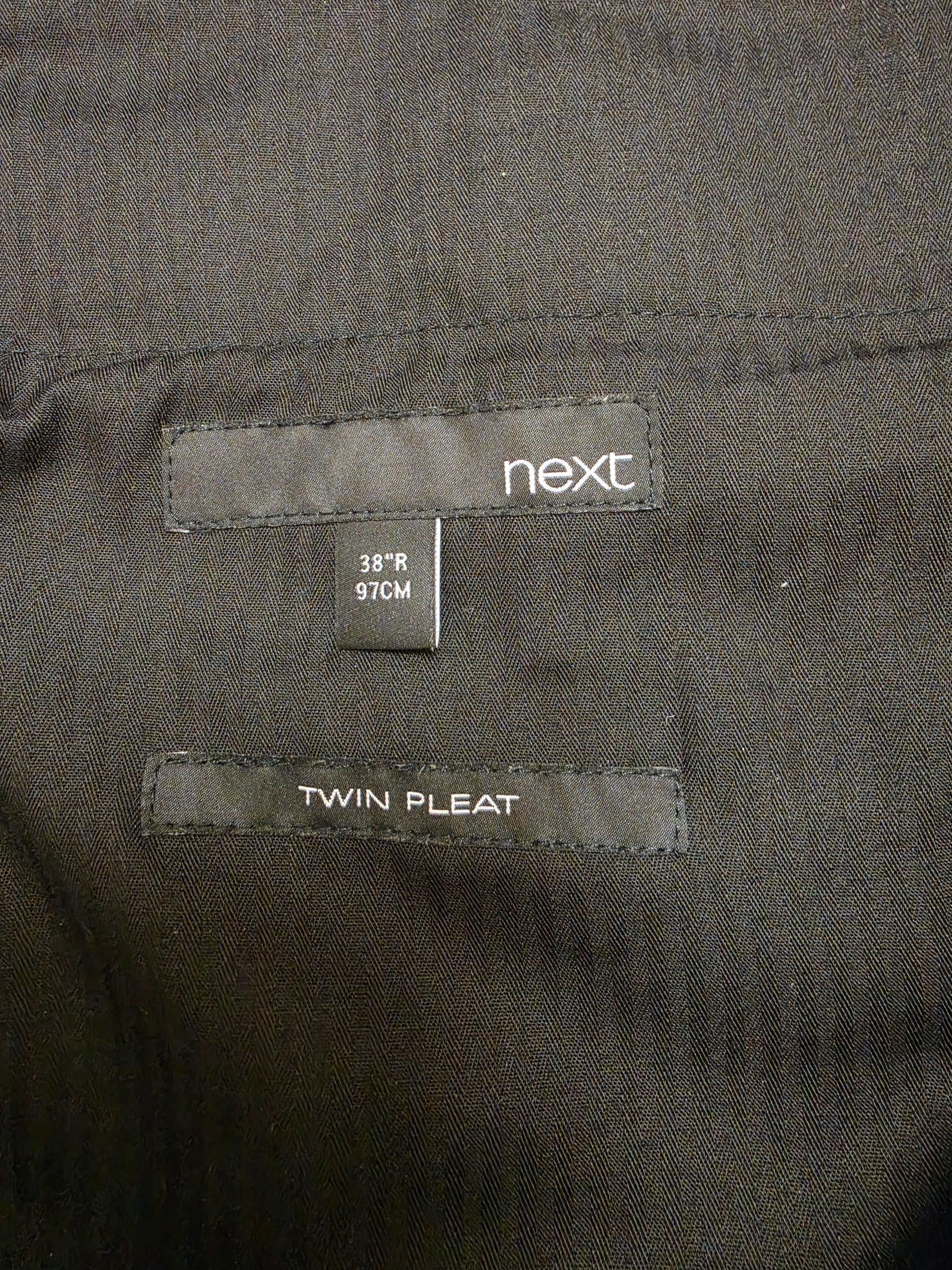 Close-up of a Next size 38 R / 97CM, and a twin pleat marking size label