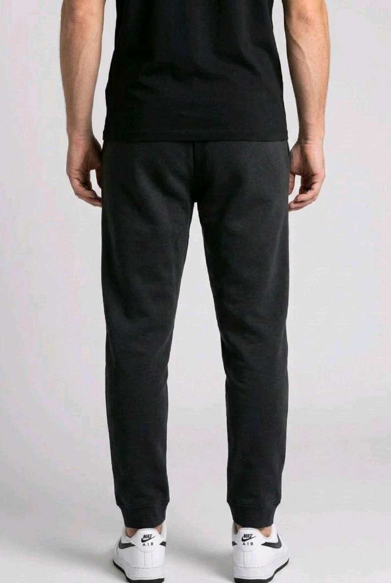 Man wearing black joggers back view