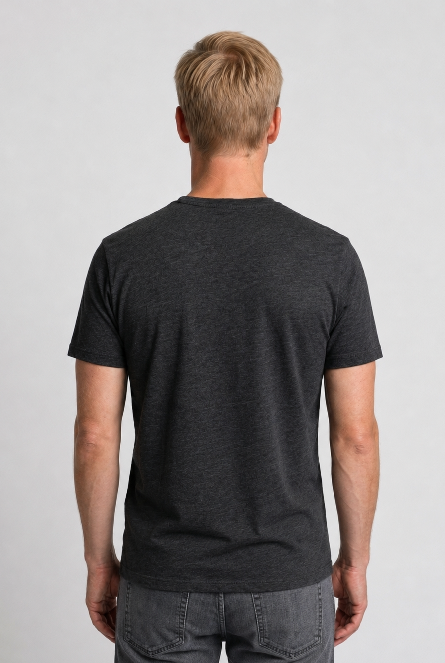Man wearing a charcoal grey t-shirt and gray jeans