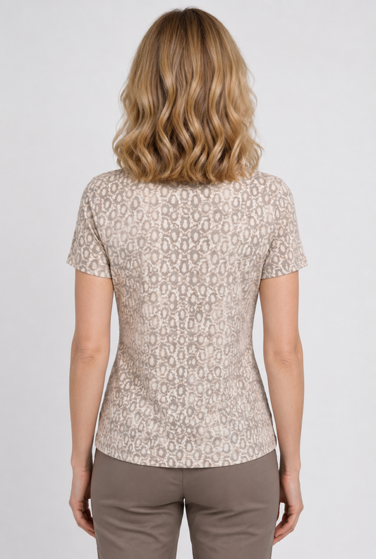 A woman viewed from the back wearing a short-sleeve beige top 