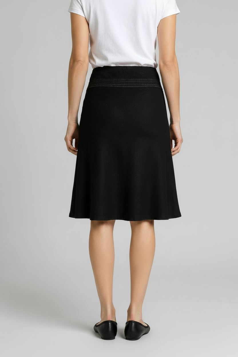 Person wearing a black skirt and white t shirt