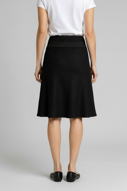 Person wearing a black skirt and white t shirt