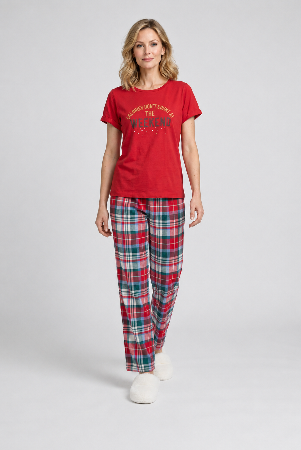 Woman wearing a red pajama top and plaid trousers