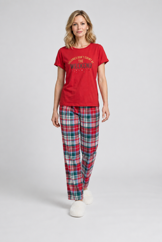 Woman wearing a red pajama top and plaid trousers