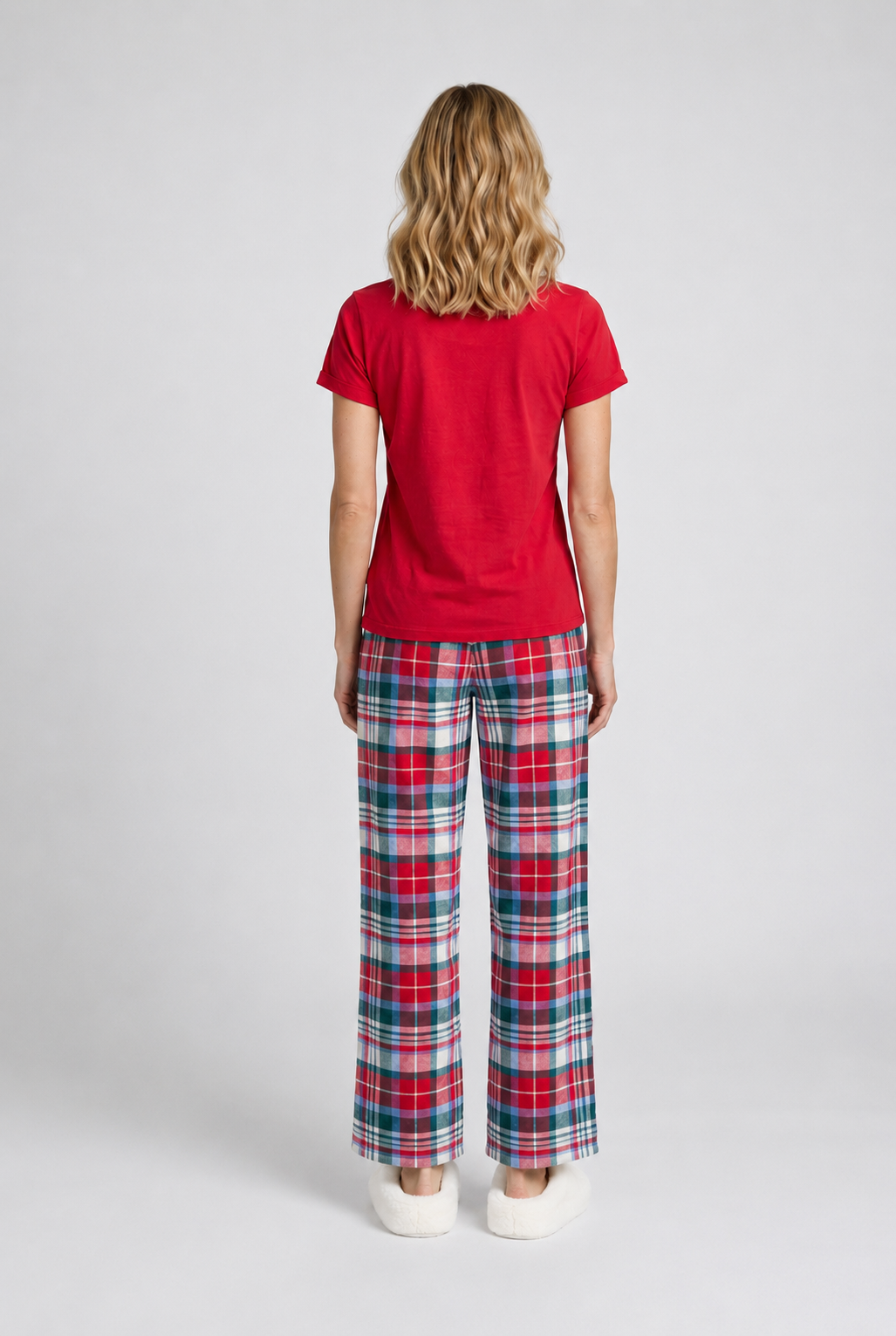 Woman wearing a red t-shirt and plaid trousers