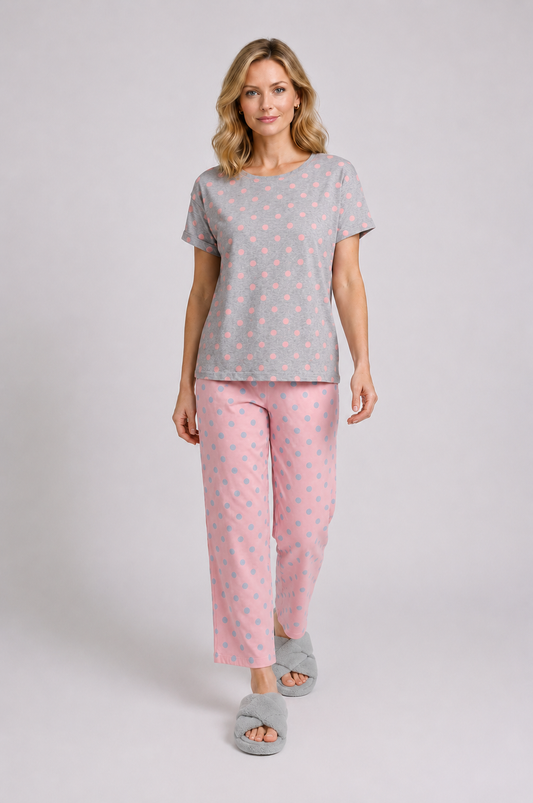 Woman wearing a grey t-shirt and pink pyjama set