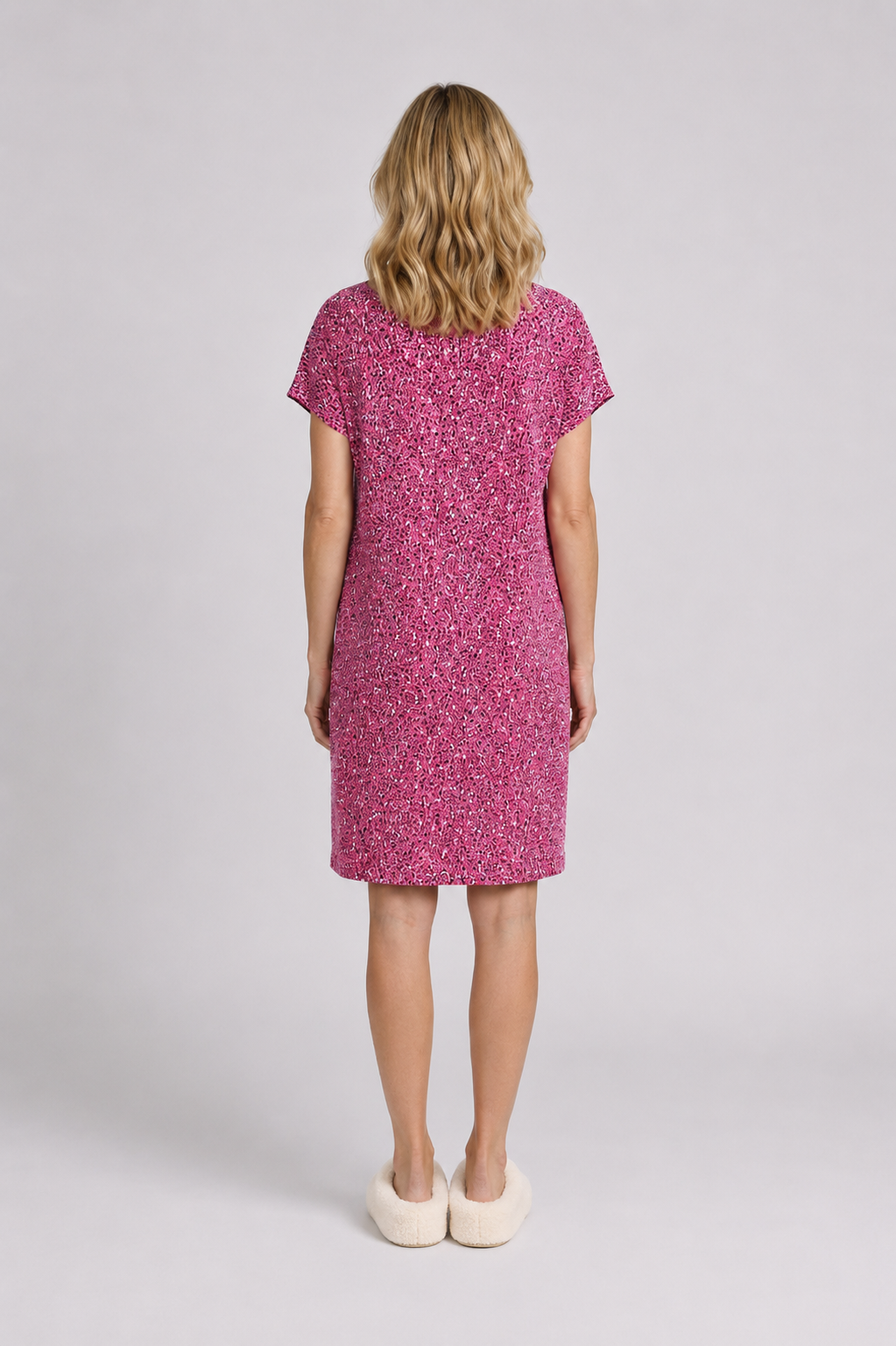 Woman wearing a pink nightdress with a subtle pattern 
