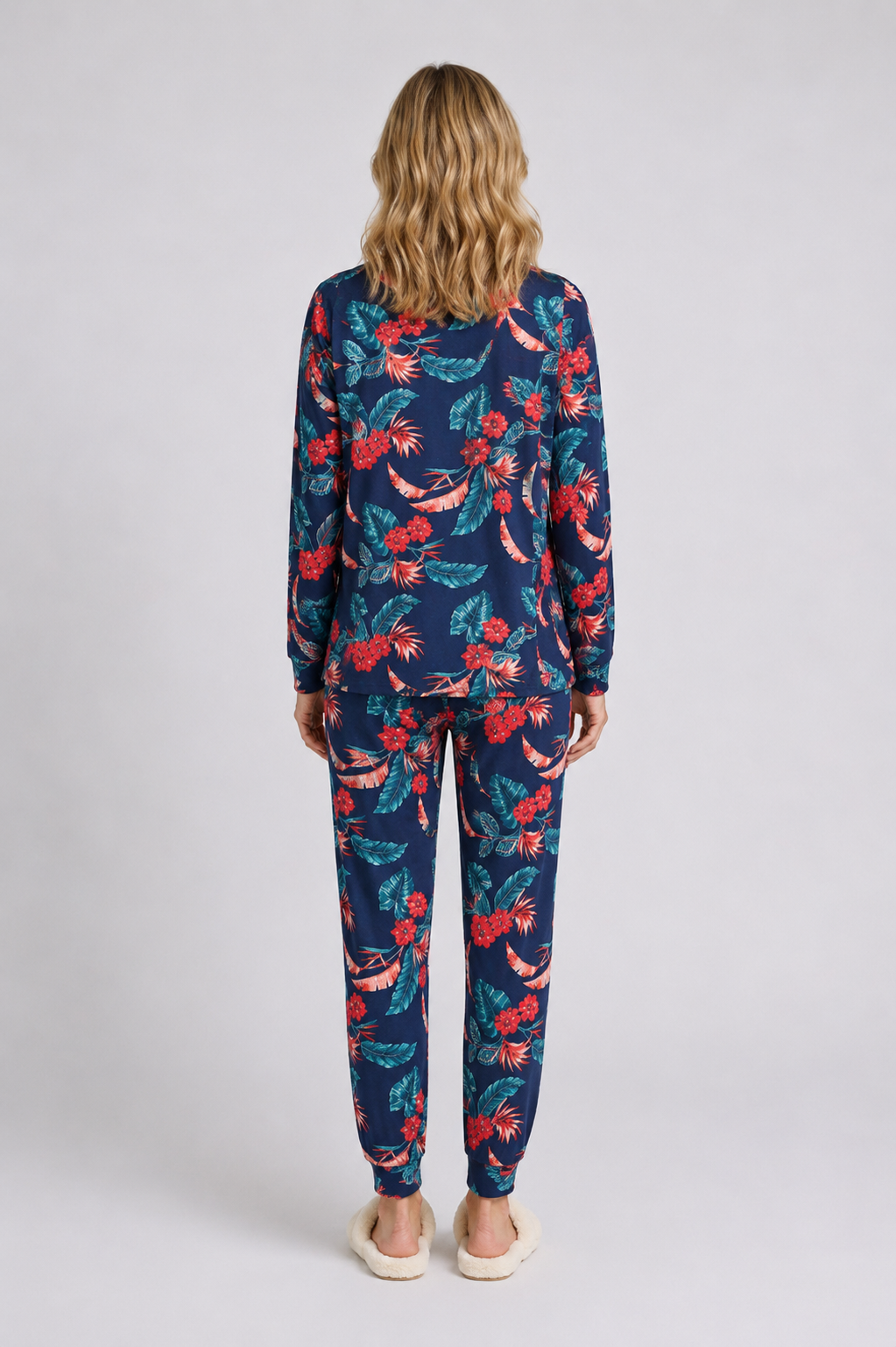 Woman wearing a navy floral pajama set 