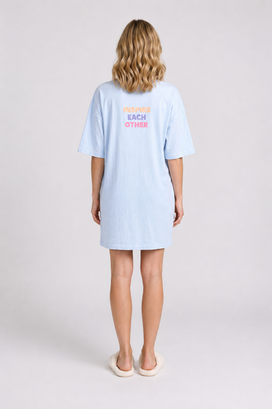 Person wearing a light blue nightdress with text on the back 