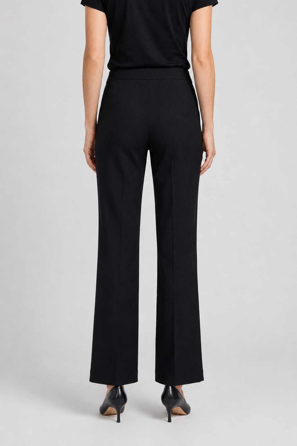 Woman wearing black trousers and a black top