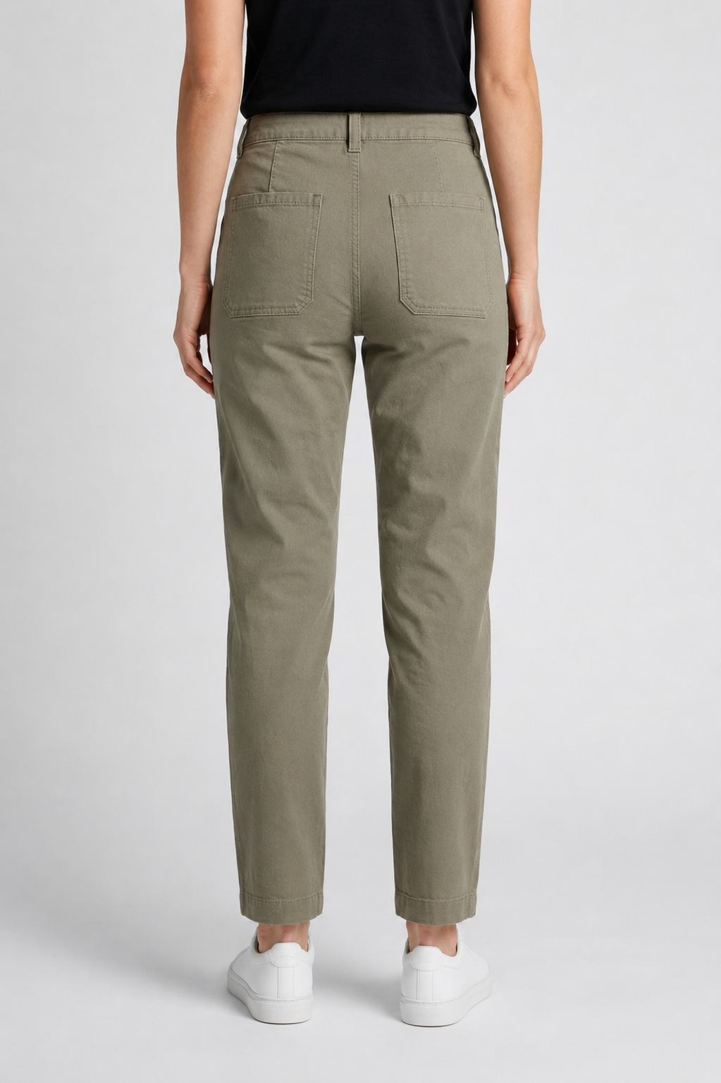 Woman wearing khaki trousers back view