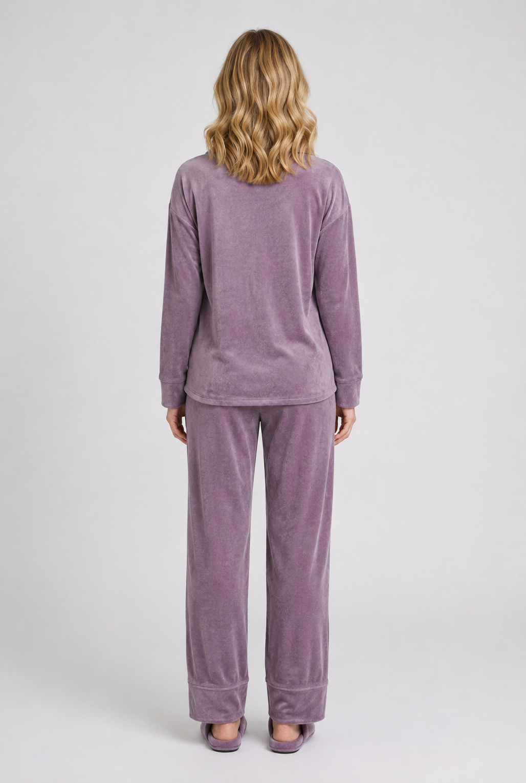 Person wearing a purple velour pyjama set