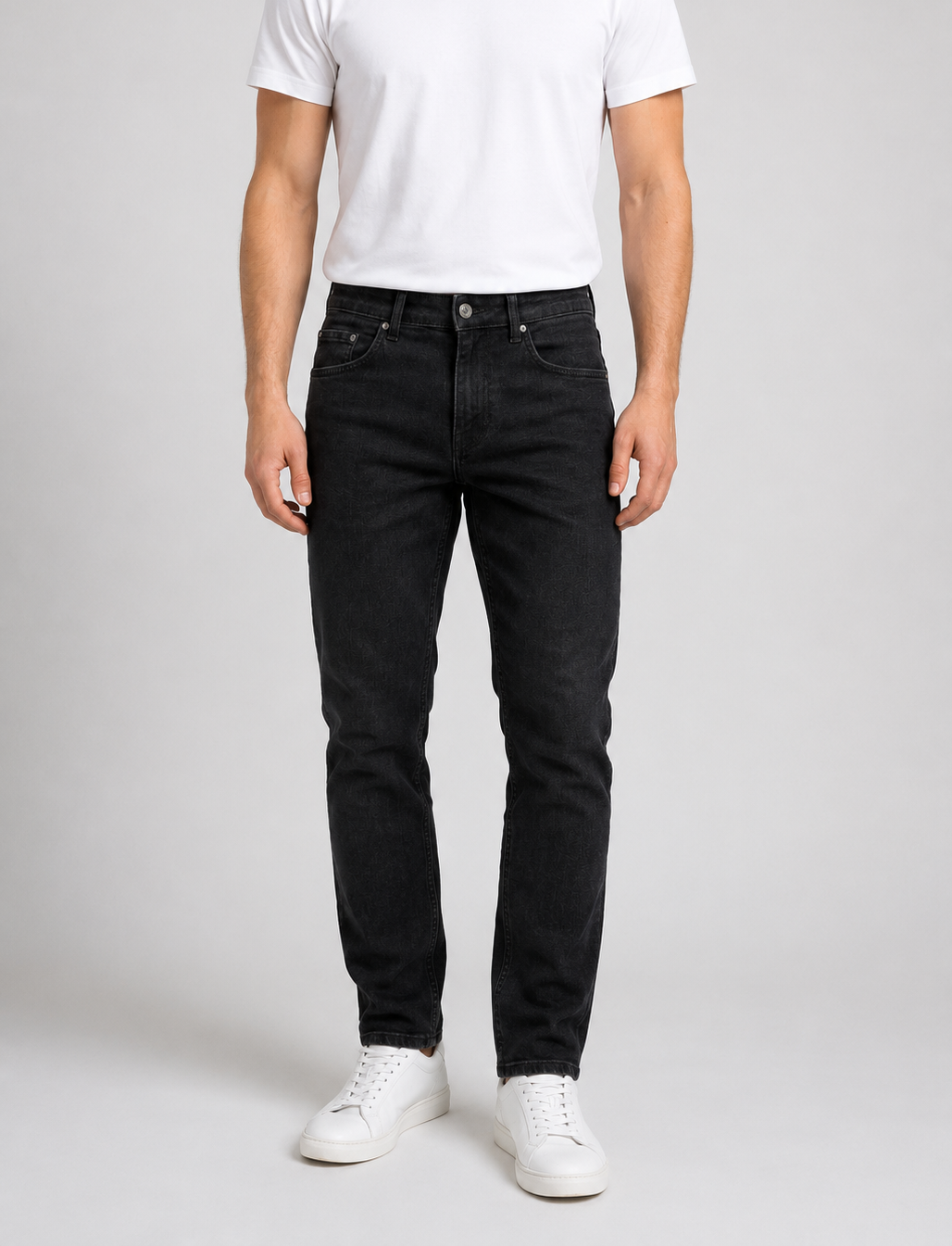 Man wearing a pair of black jeans with a white t shirt