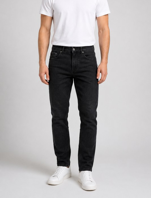 Man wearing a pair of black jeans with a white t shirt