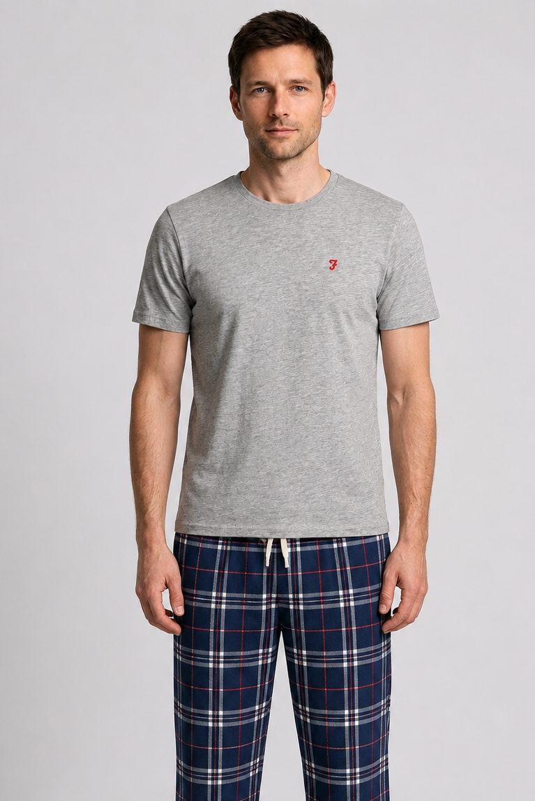 Man wearing a grey t shirt with plaid bottoms