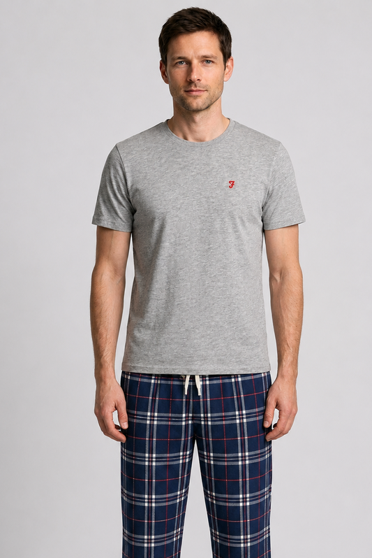 Man wearing a grey t shirt with plaid bottoms