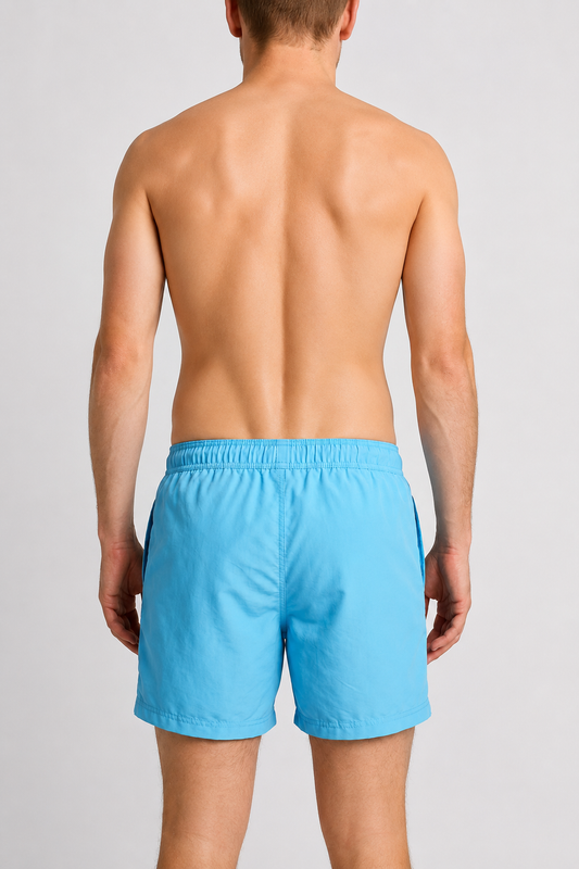 Man wearing blue swim shorts back view