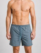 Man wearing blue swim shorts