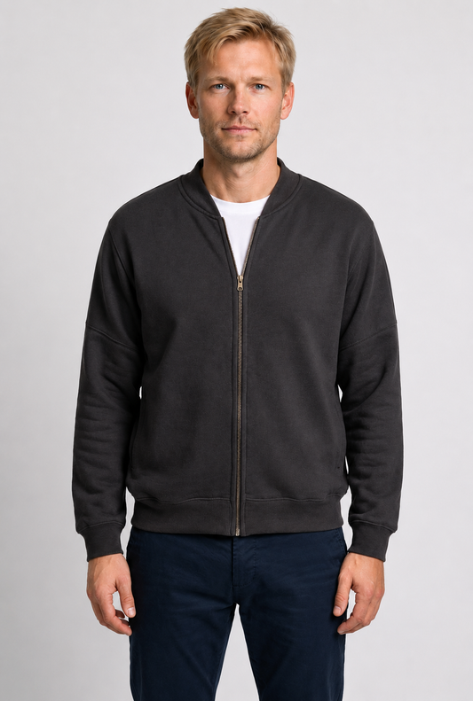 Man wearing a grey zip-up sweatshirt 