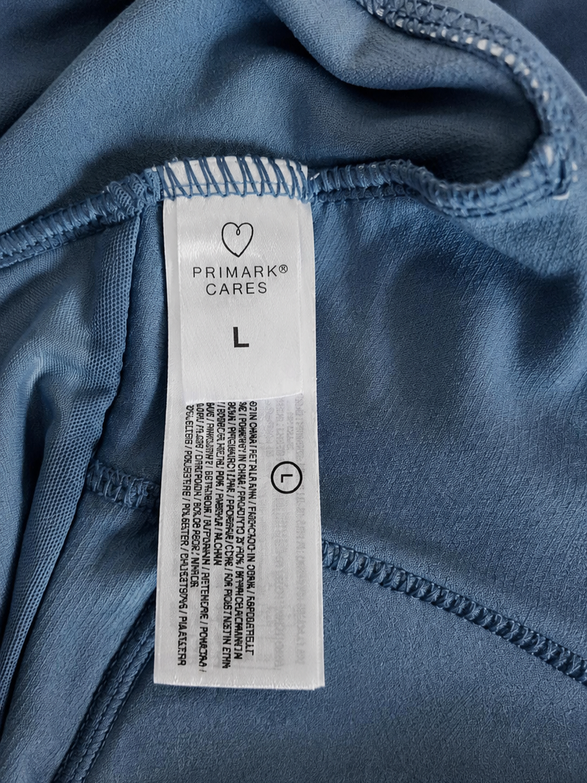 Close-up of a Primark label on blue fabric