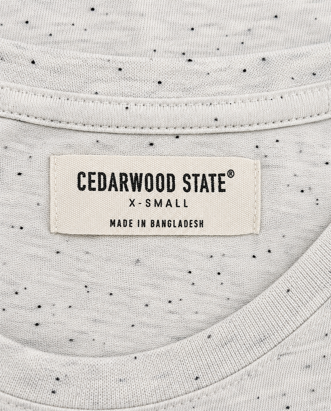 Close-up of a label on a garment with 'Cedarwood State' branding.