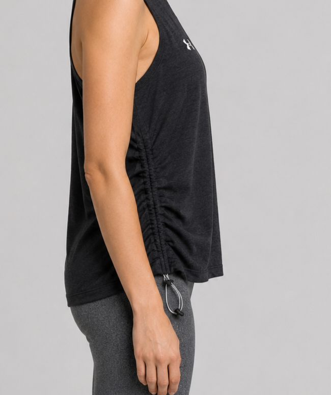 Person wearing a black sleeveless top with a brand logo side view