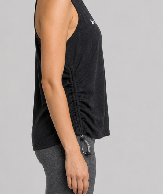 Person wearing a black sleeveless top with a brand logo side view