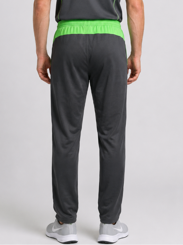 Man wearing grey Nike Tracksuit bottoms with green waistband 