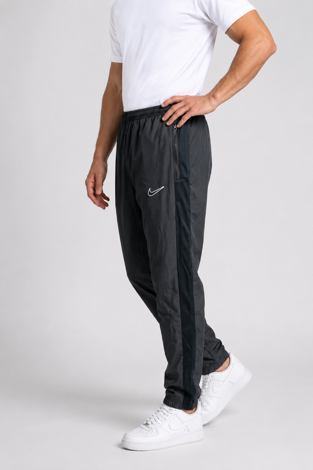 Man wearing black Nike tracksuit bottoms