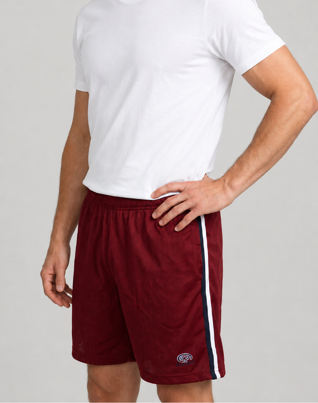 Man wearing red shorts and a white t shirt side view