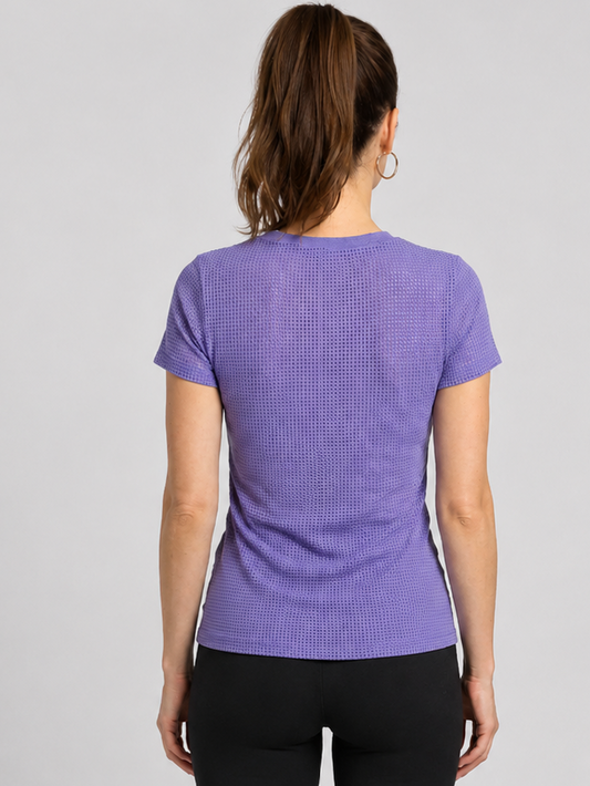 Woman wearing a purple textured adidas t-shirt 